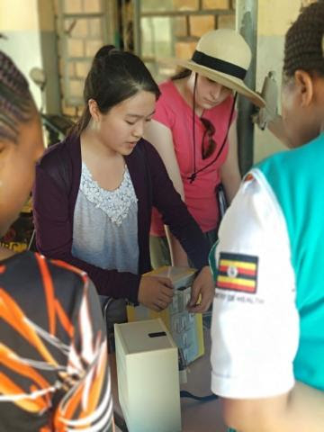 student_demonstrates_vaccine_carrier_prototype to health_care_workers