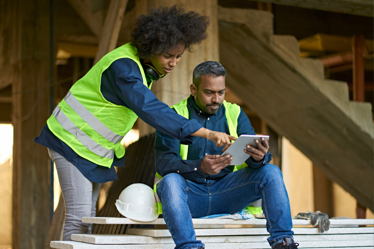 Coworkers discussing over digital tablet at site