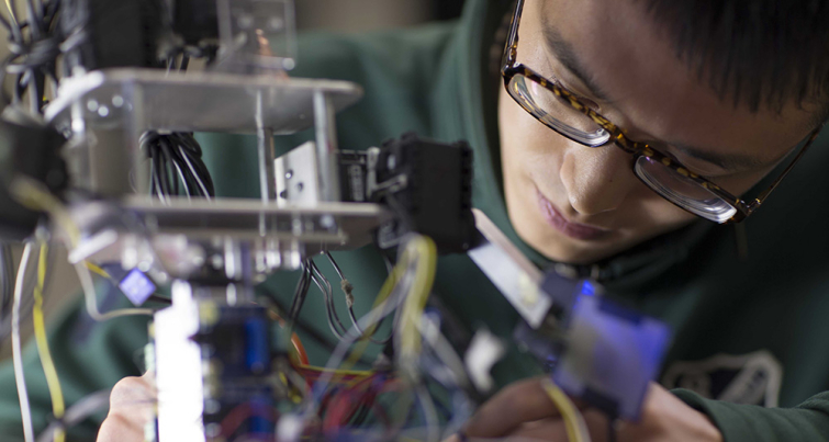 student working on a robot